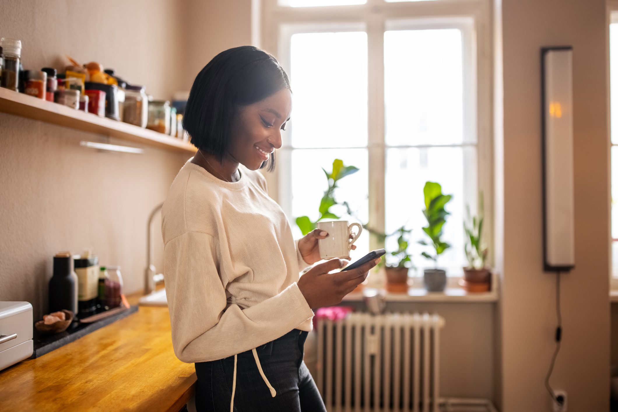 Smiling woman looking down at her phone